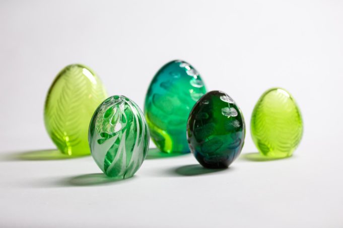 Elina Salosen taideteoksessa on viisi munanmuotoista, vihreän ja keltaisen sävyissä hehkuvaa lasisoikiota.